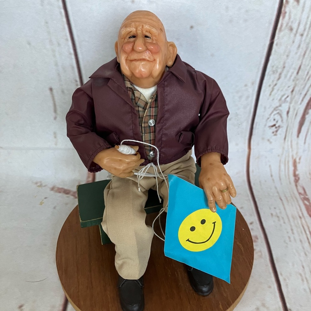 Elderly Man Figurine with Smiley Face kite